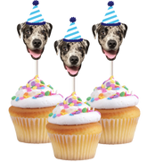 Three cupcakes with dog faces wearing party hats, indicating a dog birthday celebration.